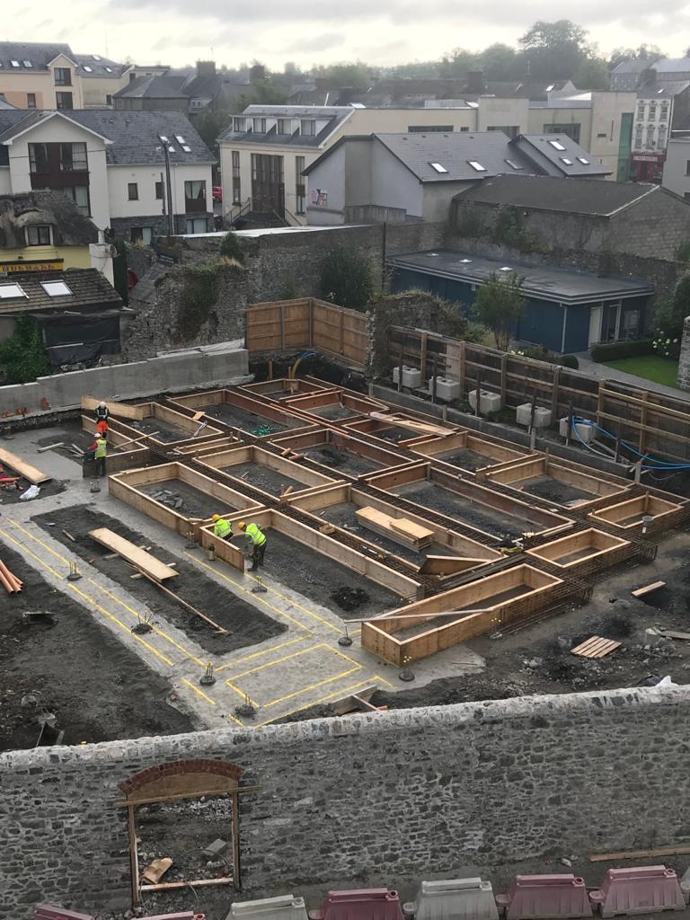 workers setting up form work for concrete during the construction phase of a hotel